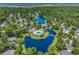 Aerial view of a community featuring homes around a beautiful lake, ponds, and mature trees at 67 Camden Circle, Pawleys Island, SC 29585