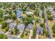 Scenic aerial view of homes near a pond and pool in lush community at 67 Camden Circle, Pawleys Island, SC 29585