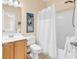 Bathroom with light wood cabinets, ceramic tile flooring, white countertops, and a shower and tub combo at 67 Camden Circle, Pawleys Island, SC 29585