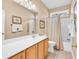 Bathroom featuring tile floors, oak cabinets, a white countertop, and a shower and tub combo with curtain at 67 Camden Circle, Pawleys Island, SC 29585