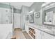 Bathroom with double sinks, marble countertops, white cabinets, a glass enclosed shower, and separate tub at 67 Camden Circle, Pawleys Island, SC 29585