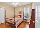 Comfortable bedroom showcasing wood floors, a four poster bed, and a window at 67 Camden Circle, Pawleys Island, SC 29585