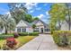 Charming single story home with driveway, manicured lawn, and colorful flower beds at 67 Camden Circle, Pawleys Island, SC 29585