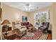 Living room with light colored walls, a ceiling fan, a large window, and a decorative rug at 67 Camden Circle, Pawleys Island, SC 29585