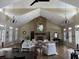 Spacious living room boasts vaulted ceilings, stone fireplace, and elegant furnishings for entertaining at 67 Camden Circle, Pawleys Island, SC 29585