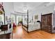 Bright primary bedroom with a four poster bed, tray ceiling, and lots of natural light at 67 Camden Circle, Pawleys Island, SC 29585