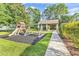 Community playground with slide, swings, and picnic area offers outdoor recreation near walking path at 67 Camden Circle, Pawleys Island, SC 29585