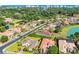 An aerial view of the neighborhood featuring mature trees, a neighborhood pond, and attractive landscaping at 7202 Seville Dr., Myrtle Beach, SC 29572