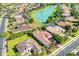 Aerial view of the community showcasing lush landscaping, a serene lake, and well-maintained homes at 7202 Seville Dr., Myrtle Beach, SC 29572