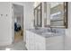 Elegant bathroom featuring double sinks with marble countertops and a walk-in closet at 7202 Seville Dr., Myrtle Beach, SC 29572