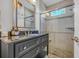 Well-lit bathroom featuring dark vanity and glass enclosed shower at 7202 Seville Dr., Myrtle Beach, SC 29572