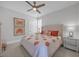 Bright bedroom with a ceiling fan, neutral carpet, and patterned comforter at 7202 Seville Dr., Myrtle Beach, SC 29572