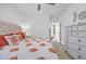 Bedroom features a bed with decorative coral patterned comforter and side table at 7202 Seville Dr., Myrtle Beach, SC 29572