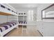Bright bedroom featuring bunk beds, dresser, and window with shutters at 7202 Seville Dr., Myrtle Beach, SC 29572