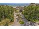 Inviting community entrance surrounded by lush landscaping and palm trees, leading to the beach at 7202 Seville Dr., Myrtle Beach, SC 29572
