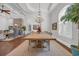 Formal dining room featuring a long wood table, chandelier, and stone fireplace at 7202 Seville Dr., Myrtle Beach, SC 29572
