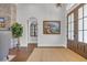 Inviting foyer with hardwood floors, a jute rug, artwork and an arched entry leading to other rooms at 7202 Seville Dr., Myrtle Beach, SC 29572