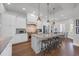 Bright and modern kitchen featuring white cabinets, granite countertops, stainless steel appliances, and island seating at 7202 Seville Dr., Myrtle Beach, SC 29572
