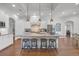 Stylish kitchen with white cabinetry, granite counters, stainless appliances, and a large island with seating at 7202 Seville Dr., Myrtle Beach, SC 29572