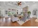 Comfortable living room featuring a stone fireplace, wood floors, coffered ceilings, and plenty of natural light at 7202 Seville Dr., Myrtle Beach, SC 29572
