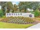 Well-maintained community sign with beautiful landscaping and colorful flowers at 7202 Seville Dr., Myrtle Beach, SC 29572