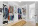 Organized walk-in closet with custom shelving, hanging racks, and a seating area at 7202 Seville Dr., Myrtle Beach, SC 29572