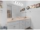 Bathroom featuring a double vanity with white cabinets and a large mirror at 728 Churchill Dr., Myrtle Beach, SC 29579