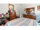 This cluttered bedroom has wooden dressers and is brightly illuminated with an open door at 728 Churchill Dr., Myrtle Beach, SC 29579