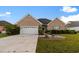 Charming single-story brick home featuring an attached two-car garage and manicured landscaping at 728 Churchill Dr., Myrtle Beach, SC 29579