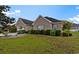Charming brick home with a well-manicured lawn and mature landscaping enhancing its curb appeal at 728 Churchill Dr., Myrtle Beach, SC 29579