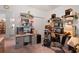 The second view of this cluttered home office features storage shelves and multiple desks at 728 Churchill Dr., Myrtle Beach, SC 29579
