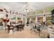 Light-filled sunroom with multiple windows, a glass table, and cozy seating at 728 Churchill Dr., Myrtle Beach, SC 29579