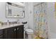A well-lit bathroom featuring a vanity with a sink and a shower with a colorful curtain at 815 Murray Ave., Myrtle Beach, SC 29577