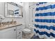 Bathroom featuring a vanity with starfish, a shower with a blue-and-white striped curtain at 815 Murray Ave., Myrtle Beach, SC 29577