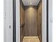 The interior of an elevator featuring wood-look walls, lighting, and a control panel at 815 Murray Ave., Myrtle Beach, SC 29577