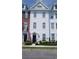 Charming three-story home with white siding, black door, and manicured landscaping at 815 Murray Ave., Myrtle Beach, SC 29577