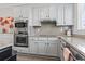 Updated kitchen with stainless steel appliances, white cabinets, granite countertops, and natural light at 815 Murray Ave., Myrtle Beach, SC 29577