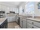 Updated kitchen with stainless steel appliances, white cabinets, granite countertops, and natural light at 815 Murray Ave., Myrtle Beach, SC 29577
