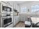 Updated kitchen with stainless steel appliances, white cabinets, granite countertops, and natural light at 815 Murray Ave., Myrtle Beach, SC 29577