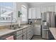 Updated kitchen with stainless steel appliances, white cabinets, granite countertops, and natural light at 815 Murray Ave., Myrtle Beach, SC 29577