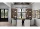 Elegant dining room with coffered ceiling, modern chandelier, and French doors, perfect for entertaining guests at 9 Sw Mashie Ct., Carolina Shores, NC 28467