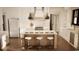 Spacious kitchen boasts white cabinets, stainless appliances, and a large island with seating and modern pendant lighting at 9 Sw Mashie Ct., Carolina Shores, NC 28467