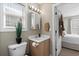 Cozy bathroom featuring a sink with vanity, toilet, window, and neutral tones with views to the bedroom at 9679 Stillwater Ct., Myrtle Beach, SC 29572