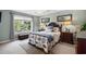 Comfortable bedroom featuring a decorative headboard, bedside tables, and a view from the window at 9679 Stillwater Ct., Myrtle Beach, SC 29572