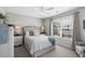 Comfortable bedroom with a ceiling fan, bright window, and cozy decor, with neutral tones and side tables at 9679 Stillwater Ct., Myrtle Beach, SC 29572