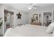Bright bedroom featuring a ceiling fan, dresser, closet, and views leading to the bathroom and living room at 9679 Stillwater Ct., Myrtle Beach, SC 29572