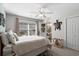 Light-filled bedroom with a ceiling fan, outdoor access, decorative turtle art, and access to an ensuite bathroom at 9679 Stillwater Ct., Myrtle Beach, SC 29572