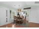 Bright dining room featuring a stylish light fixture, seating for six, and a view into the kitchen at 9679 Stillwater Ct., Myrtle Beach, SC 29572
