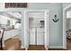 Convenient laundry area with a washer and dryer, shelving, and views into the kitchen and Primary bedroom at 9679 Stillwater Ct., Myrtle Beach, SC 29572