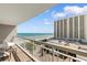 Balcony view showcasing the beautiful beach with blue umbrellas, the ocean, and the nearby building at 9820 Queensway Blvd. # 804, Myrtle Beach, SC 29572